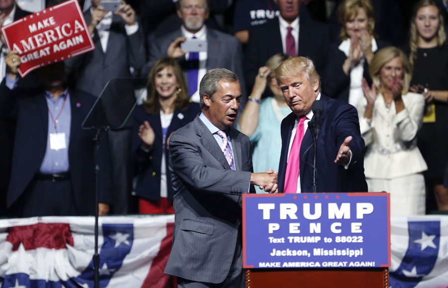 Republican presidential candidate Donald Trump welcomes Nigel Farage, ex-leader of the British UKIP party, to speak at a campaign rally in Jackson, Miss., on Wednesday.