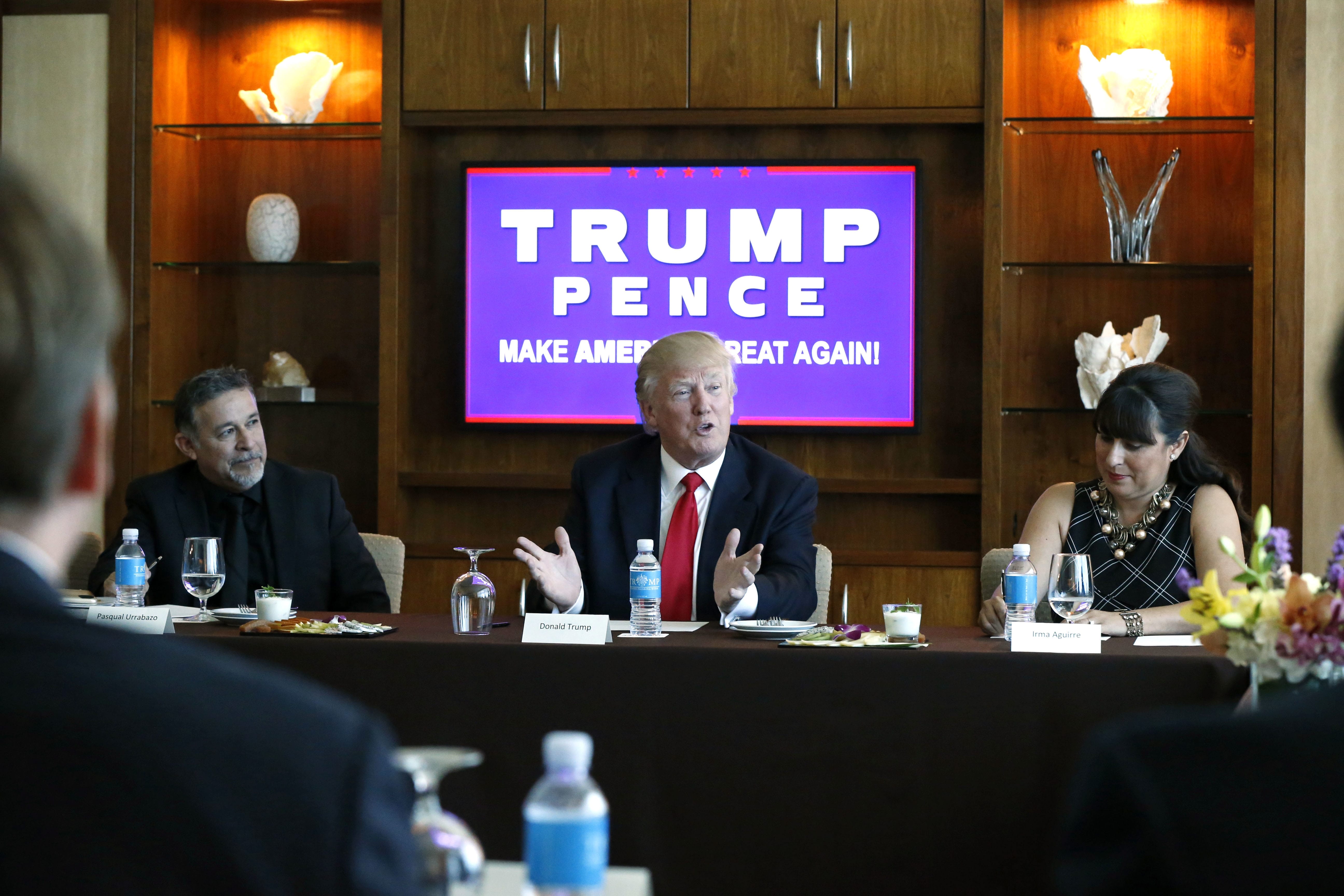Republican presidential candidate Donald Trump leads a Hispanic leaders and small business owners roundtable in Las Vegas, Friday, Aug. 26, 2016. Left is Pastor Pasqual Urrabazo, of the International Church of Las Vegas, and right is Irma Aguirre, a local business owner.