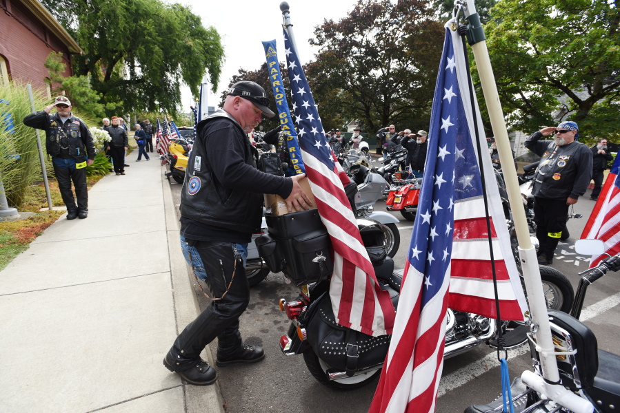 Patriot Guard Riders salute as the cremated remains of Maine Civil War soldier Jewett Williams are packed on a motorcycle Monday following a ceremony at Oregon State Hospital in Salem, Ore.