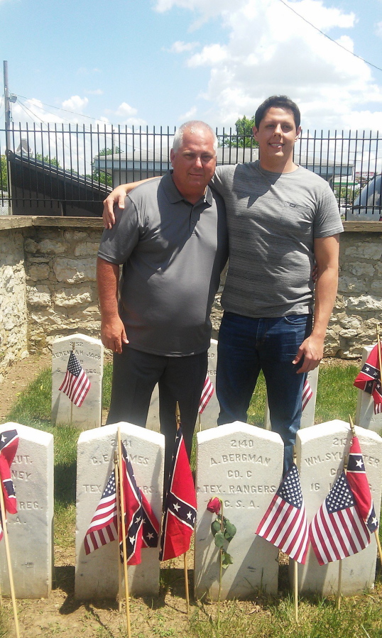In this May 30, 2016 photo, Gregory Beckman and his son, Marcus, visit the grave site of their relative Augustus Beckmann at Camp Chase Confederate Cemetery on Memorial Day weekend. The name and information on the stone is incorrect. Due to Beckman&#039;s efforts in tracking down his family history and noting that the stone is wrong, a national cemetery association will fix it.
