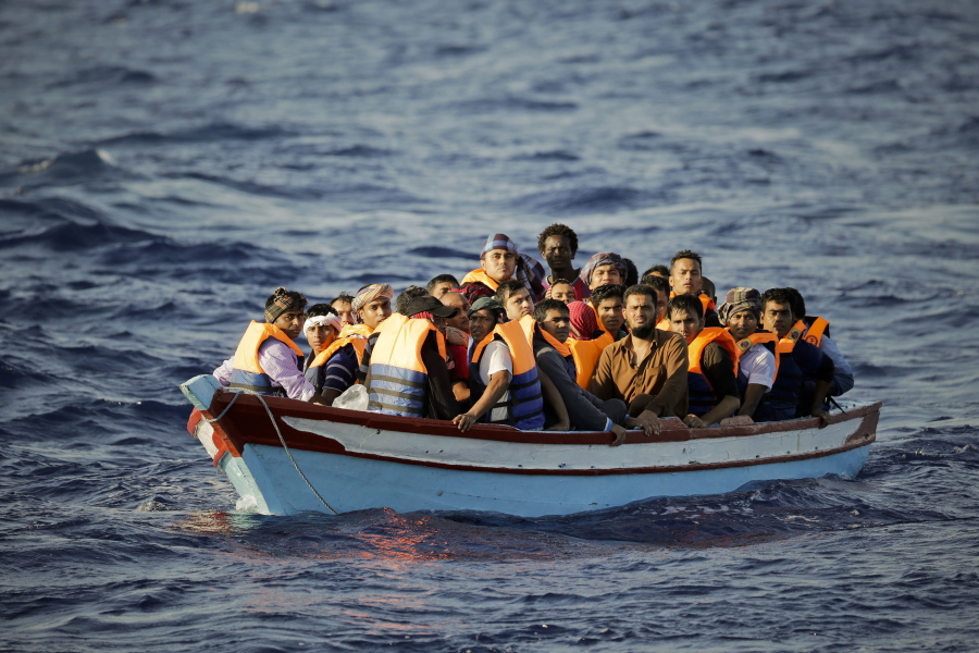 Migrants are crowded in a dinghy before being helped by a Spanish aid group Thursday in the Mediterranean Sea north of Sabratha, Libya. More than 100 were rescued from three boats.