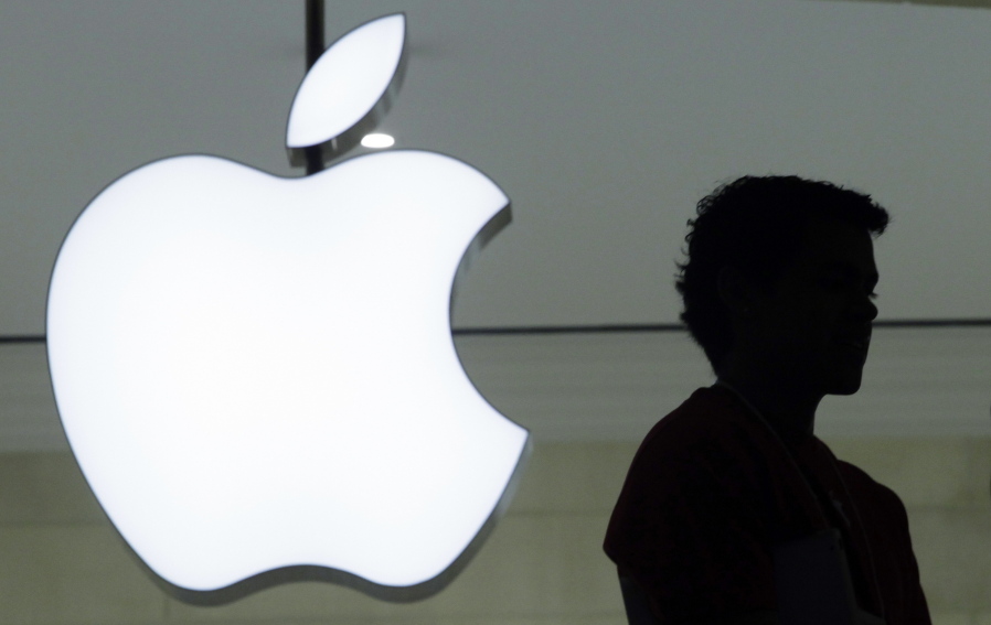 A person stands near the Apple logo at the company&#039;s store in Grand Central Terminal, in New York.