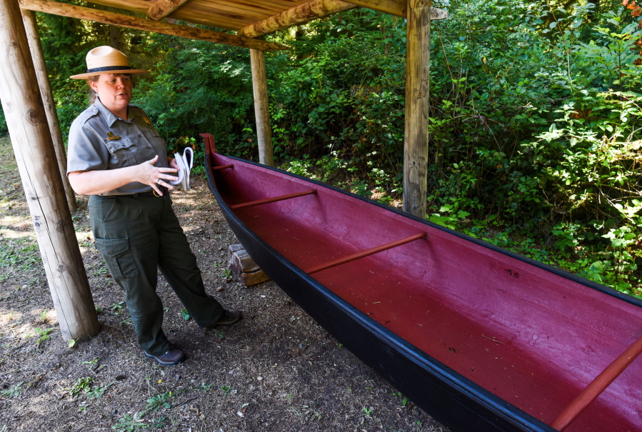 Jill Harding, who is in charge of visitor services at Lewis and Clark National Historic Park, explains the history behind the Okulam Canoe on July 25 at Fort Clatsop in Lewis and Clark National Historic Park in Astoria, Ore.