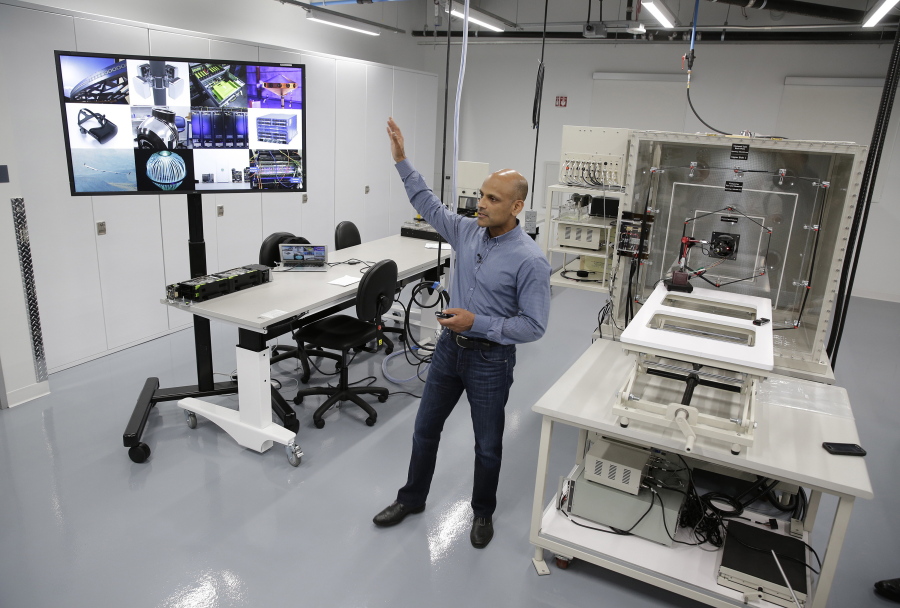 Jay Parikh, vice president of engineering, talks about Area 404, the hardware R&amp;D lab, during a tour at Facebook headquarters in Menlo Park, Calif. At right is a wind tunnel.