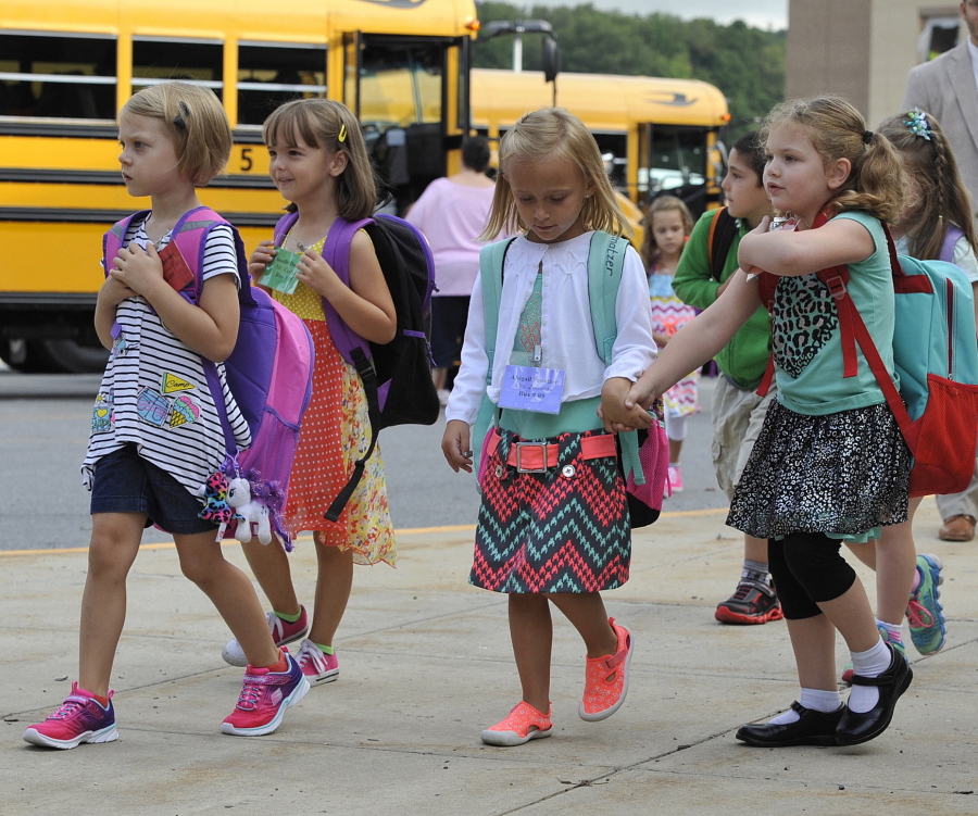 Kindergarten students at Forest Hills Elementary School in Sidman, Pa., walk to class on Monday, the first day of school.