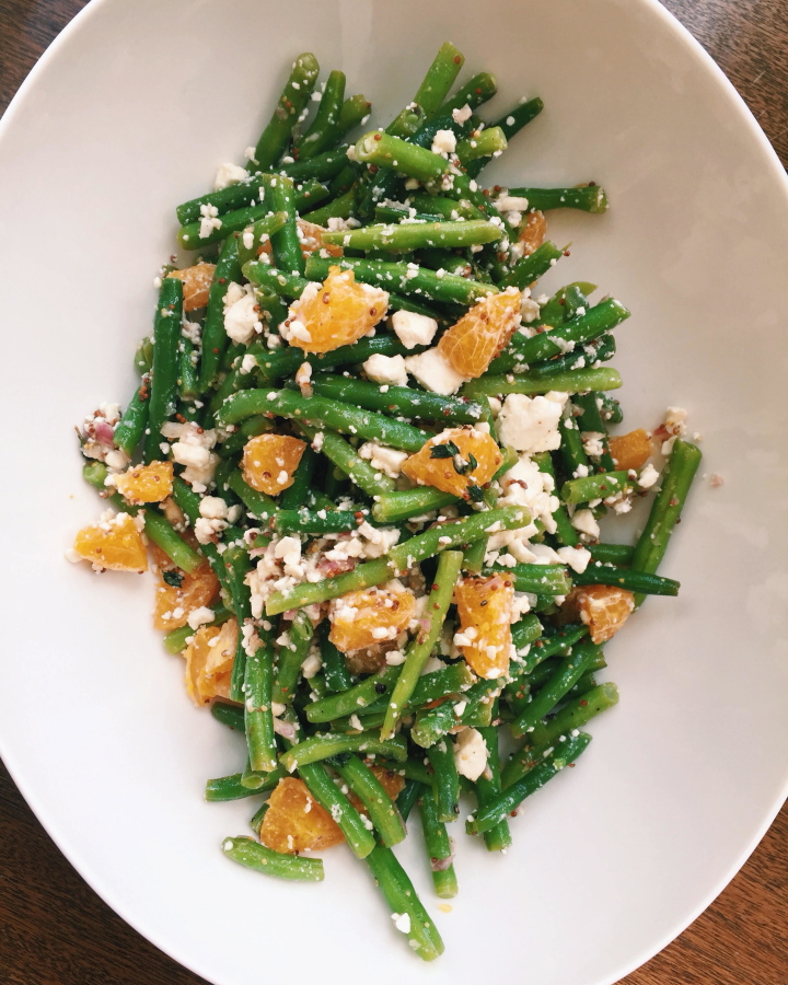 A green bean salad with clementine oranges and feta cheese (Katie Workman via AP)