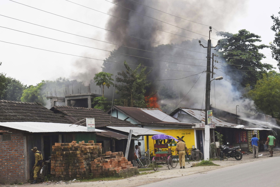 A fire burns after rebels opened fire in a crowded market at Kokrajhar, in the north-eastern Indian state of Assam, India, Friday, Aug. 5, 2016. Dozens of rebel groups have been fighting the government and sometimes each other for years in seven states in northeast India. They demand greater regional autonomy or independent homelands for the indigenous groups they represent.