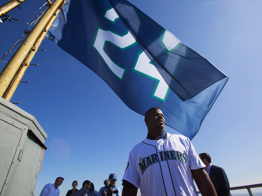 Ken Griffey Jr. looks out across the Seattle skyline after hoisting a flag with a number 24 in Mariner&#039;s colors on op of the Space Needle, Friday, Aug. 5, 2016.
