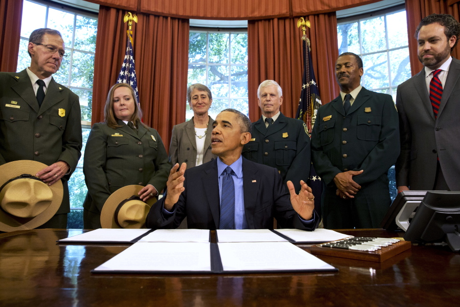 President Barack Obama, center, talks about the designation of three new national monuments; Berryessa Snow Mountain in California, Waco Mammoth in Texas, and the Basin and Range in Nevada, in 2015 in the Oval Office of the White House in Washington. Behind him from left are Victor Knox, associate director of park planning, facilities and lands of the National Park Service; April Slayton, chief of public affairs and chief spokesperson of the National Park Service; Secretary of the Interior Sally Jewell; U.S. Forest Service Chief Tom Tidwell; Randy Moore, Forest Service; and Bureau of Land Management director Neil Kornze.