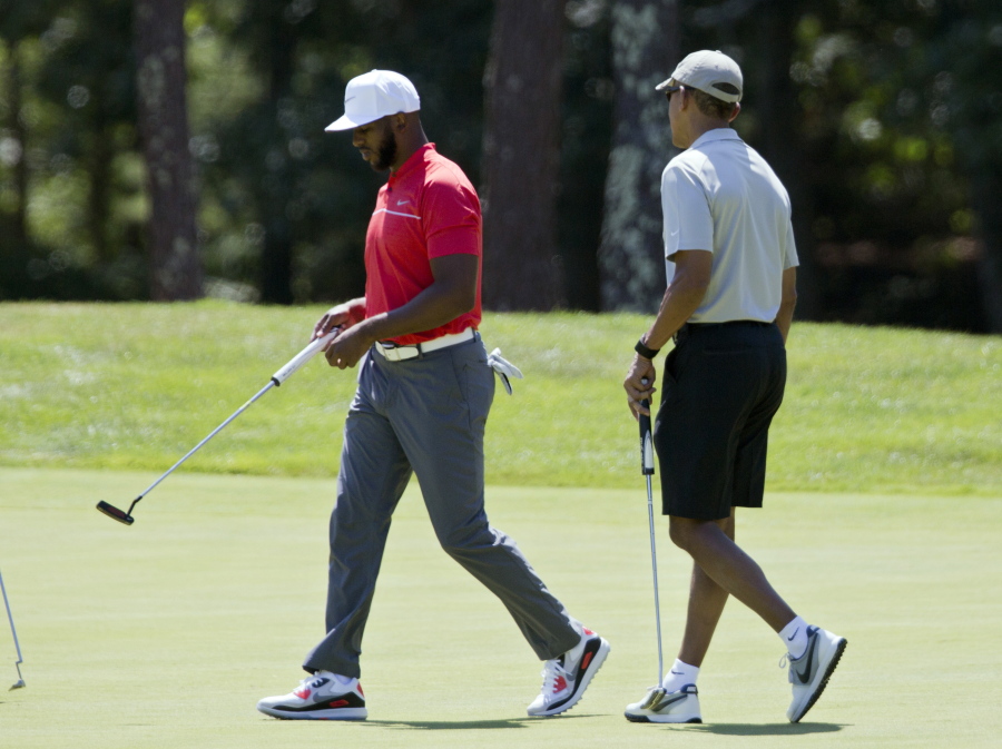 In this Aug. 7 photo, President Barack Obama and Los Angeles Clippers point guard Chris Paul walk on the first green during a round of golf at Farm Neck Golf Course in Oak Bluffs, Mass., on Martha&#039;s Vineyard. When Obama goes on vacation, he plays a lot of golf. And he likes to hang out with big-name basketball players. In his first outing, Obama joined up with Chris Paul of the Los Angeles Clippers. In the second round, it was Stephen Curry of the Golden State Warriors, and in his third and fourth rounds, Obama???s foursome included former stars Alonzo Mourning and Ray Allen.
