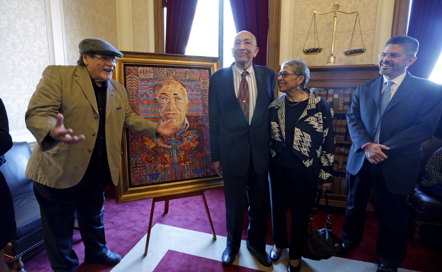 Artist Alfredo Arreguin, left, talks May 20, 2014 about his painting of former Washington state Supreme Court Justice Charles Z. Smith, standing in the middle with his wife, Eleanore &quot;Elie&quot; Martinez Smith, and current Justice Steven Gonzalez, right, during an unveiling ceremony for Smith&#039;s portrait at the Temple of Justice in Olympia, Wash. Smith, Washington state&#039;s first black Superior Court judge and state Supreme Court justice, died Sunday in Seattle, at 89.