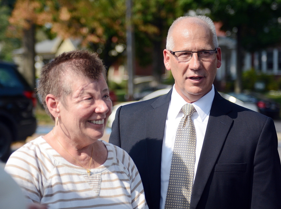 Sharon and Randy Budd talk in September with friends and relatives outside the county house in Lewisburg, Pa., after four young men were sentenced to time behind bars for throwing a rock off a highway overpass.