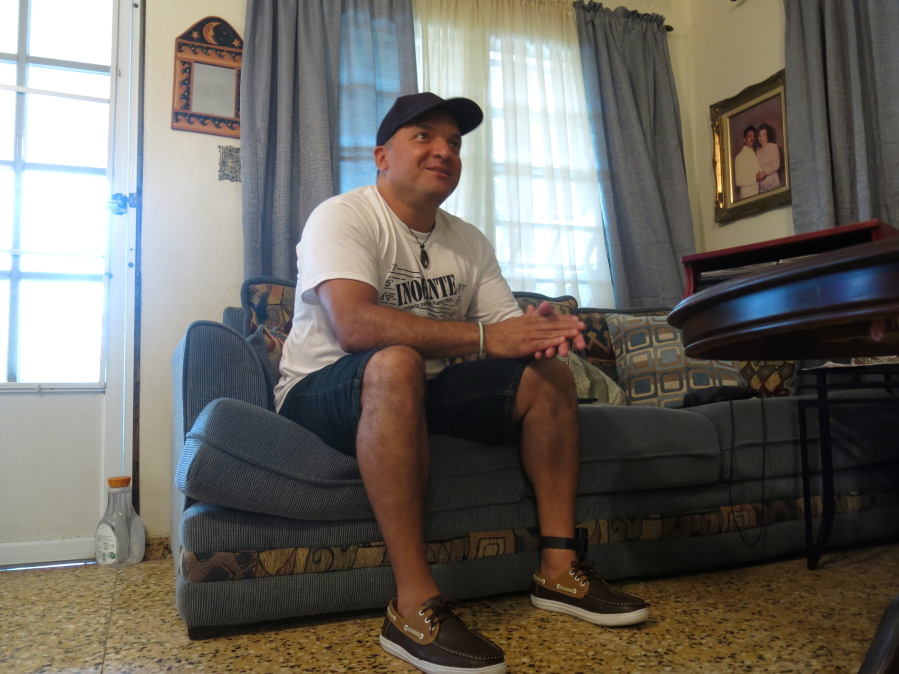 Nelson Ortiz talks to a relative in Moca, Puerto Rico. He is one of three men who could go free more than 20 years after convicted of kidnapping, raping and killing a woman thanks to a new DNA law being applied for the first time in Puerto Rico.