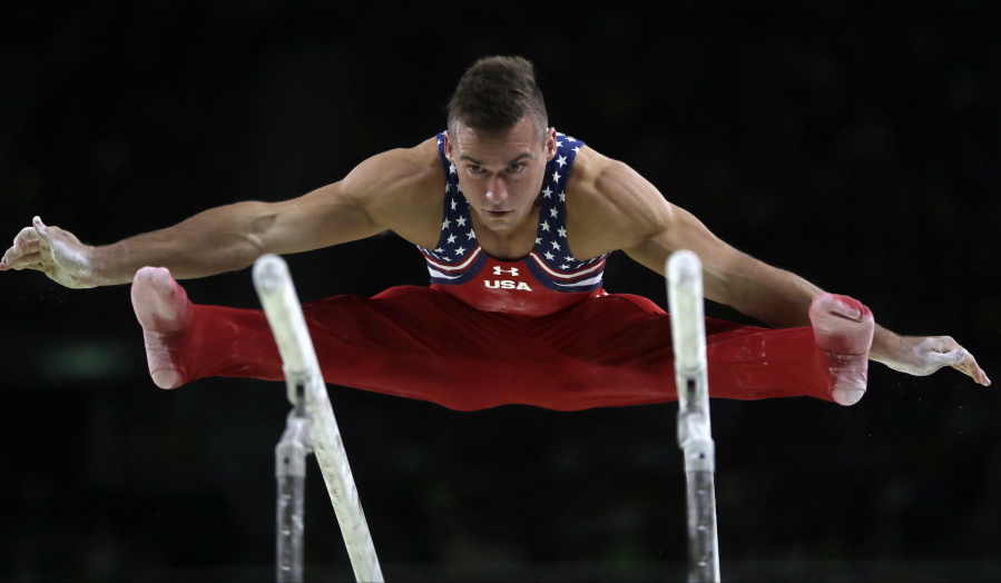 United States&#039; Sam Mikulak performs on the parallel bars during the artistic gymnastics men&#039;s team final at the 2016 Summer Olympics in Rio de Janeiro, Brazil, Monday, Aug. 8, 2016.