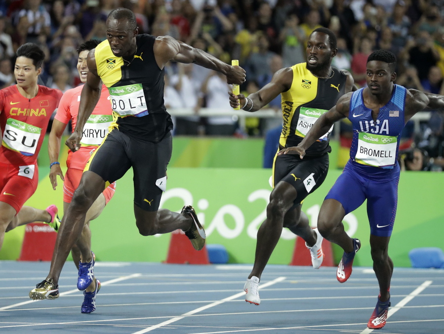 Jamaica&#039;s Nickel Ashmeade, second right, passes the baton to Usain Bolt in the men&#039;s 4 x 100-meter relay final, during the athletics competitions of the 2016 Summer Olympics at the Olympic stadium in Rio de Janeiro, Brazil, Friday, Aug. 19, 2016.