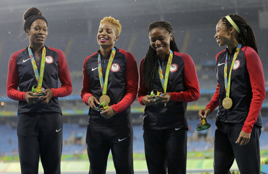 The United States women&#039;s 4x400 meter relay team members, Courtney Okolo, Natasha Hastings, Phyllis Francis and Allyson Felix stand on the podium with their gold medals during athletics competitions at the Summer Olympics inside Olympic stadium in Rio de Janeiro, Brazil, Saturday, Aug. 20, 2016. (AP Photo/Jae C.
