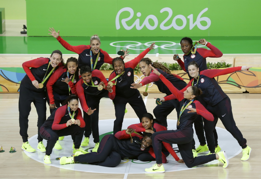 United States team members pose for a photo after the gold medal basketball game against Spain at the 2016 Summer Olympics in Rio de Janeiro, Brazil, Saturday, Aug. 20, 2016.