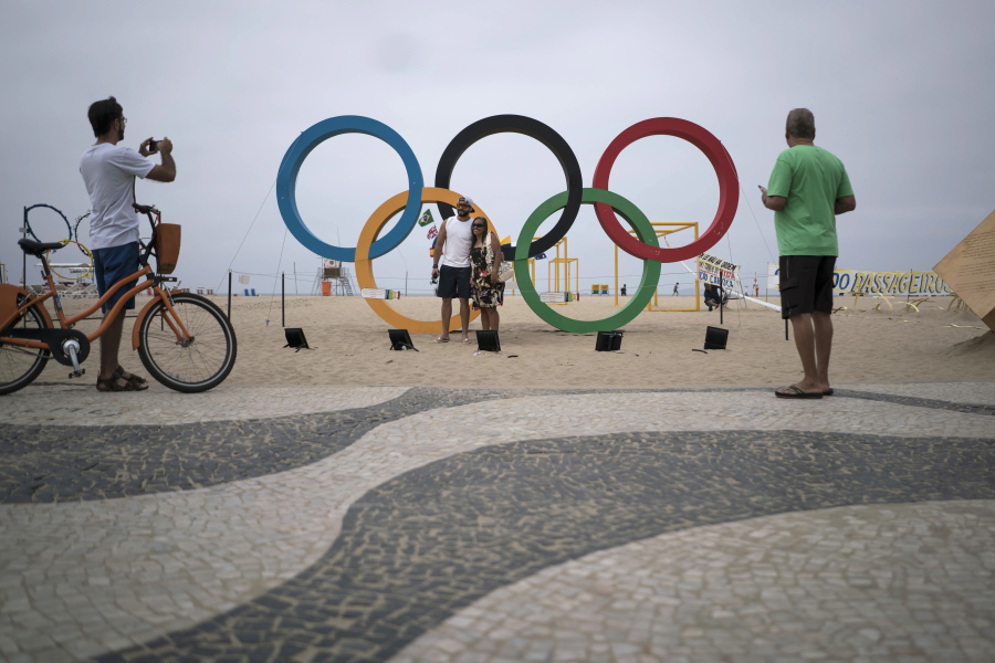 People take photos by the Olympic rings decorating Copabana Beach in Rio de Janeiro, Brazil. In the city&#039;s 2009 Olympic bid document, authorities pledged the games would &#039;regenerate Rio&#039;s magnificent waterways.&#039; A promised billion-dollar investment in cleanup programs was meant to be among the games&#039; most important legacies, but once more, the lofty promises have ended in failure.