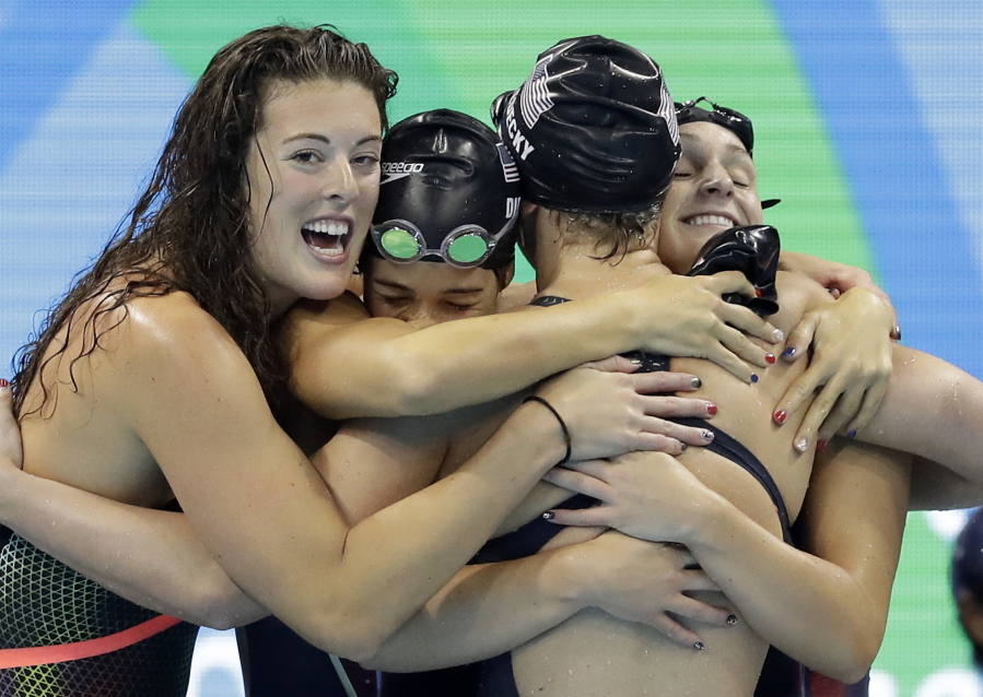 United States&#039; Katie Ledecky, second from right, celebrates with her teammates Allison Schmitt, Maya DiRado and Leah Smith, from left, after coming first in the women&#039;s 4 x 200-meter freestyle relay final.