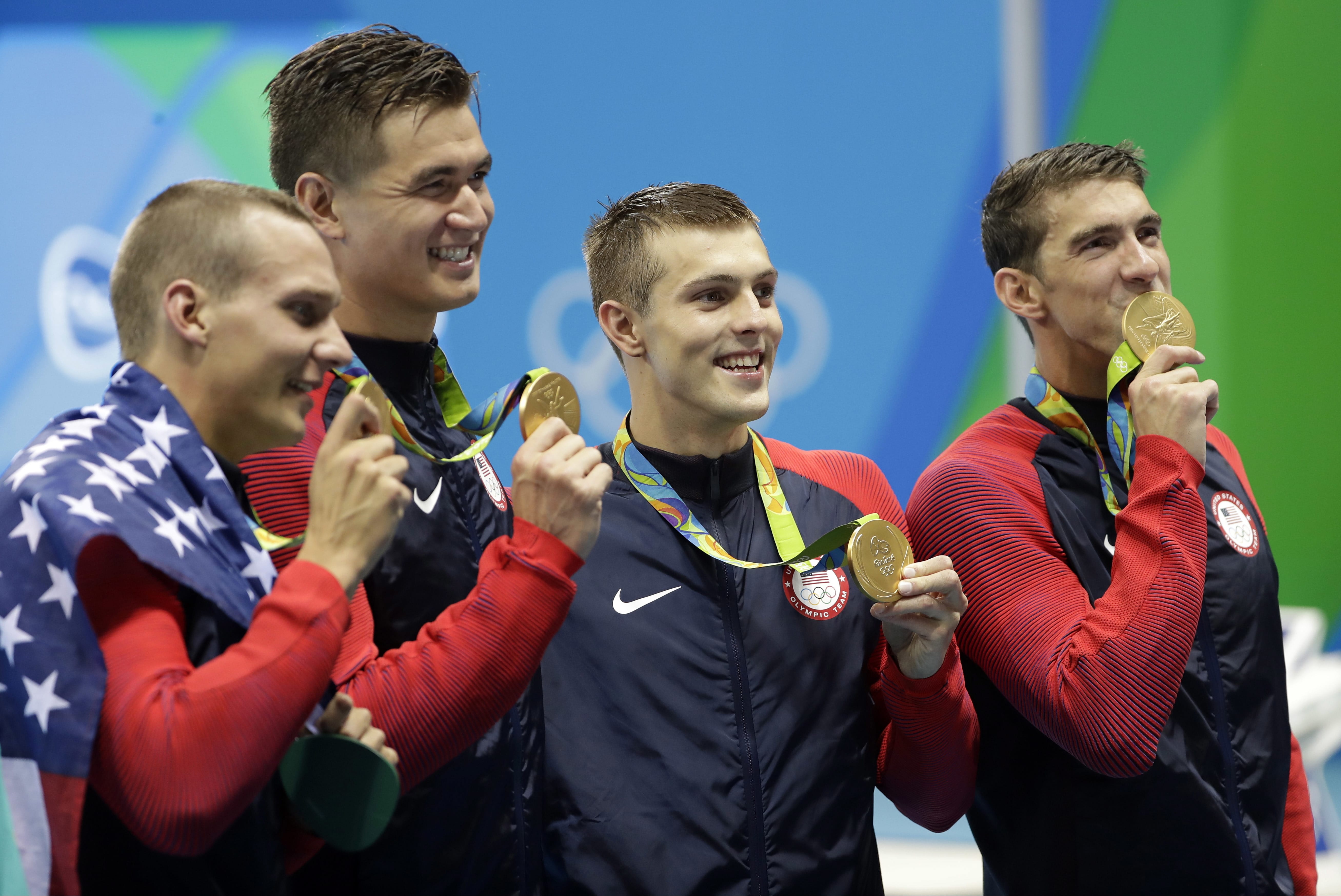 The United States team from left, Caeleb Dressel, Nathan Adrian, Ryan Held and Michael Phelps celebrate after winning the gold medal in the men's 4x100-meter freestyle relay during the swimming competitions at the 2016 Summer Olympics, Monday, Aug. 8, 2016, in Rio de Janeiro, Brazil.