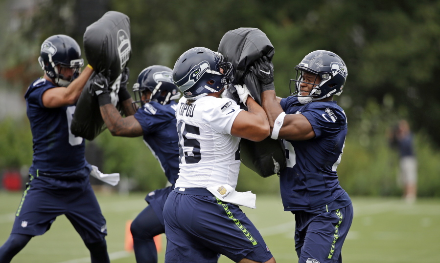Seattle Seahawks&#039; Brandon Williams, right, and Taani Tupou run through a drill during the team&#039;s NFL football training camp Saturday, July 30, 2016, in Renton, Wash.