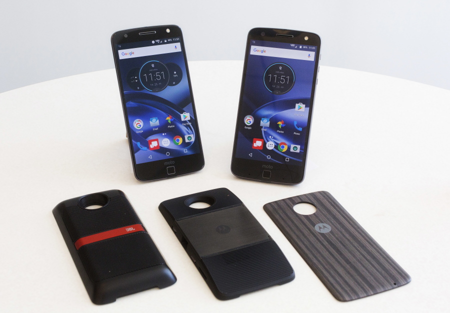 The Moto Z Droid, left, and Moto Z Force Droid phones are displayed with modules available to extend the phones&#039; functionality. The Moto Z adopts a modular design, which lets customers mix and match components, like Lego blocks. The modules are, from left, JBL speakers, a wall projector and a spare battery pack.