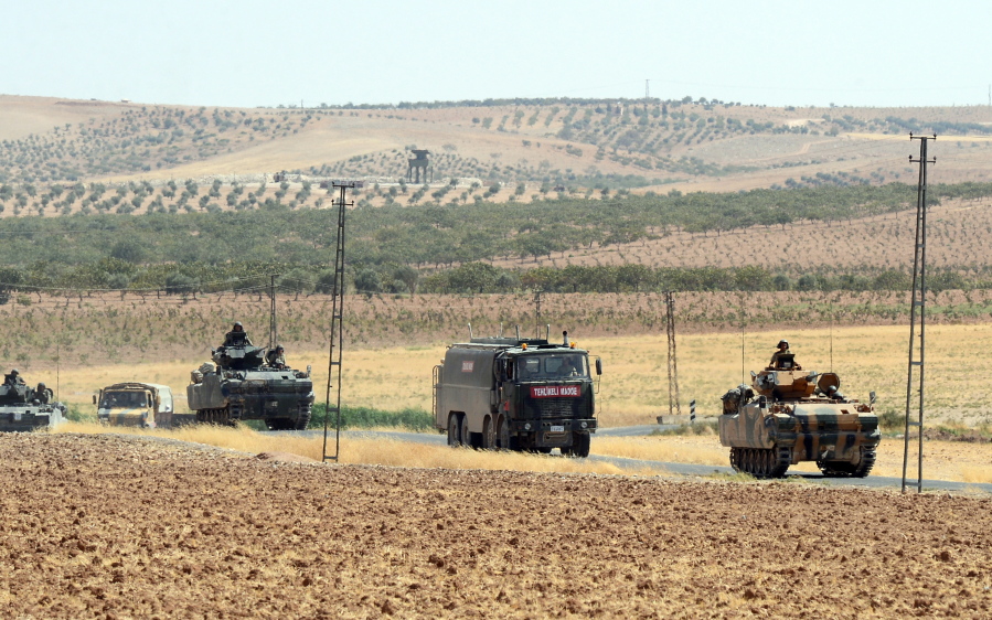 Turkish troops return from the Syrian border, in Karkamis, Turkey, Saturday.