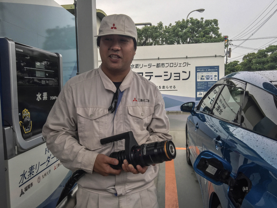 An attendant prepares to fill up a Toyota Mirai at a Fukuoka sewage treatment plant, which is creating hydrogen from biogas.