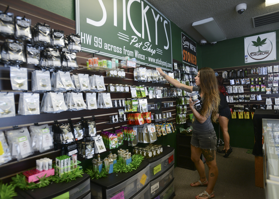 Alex Merrell, a manager at Sticky&#039;s Pot Shop in Vancouver, organizes merchandise Aug. 1. The store has been closed.