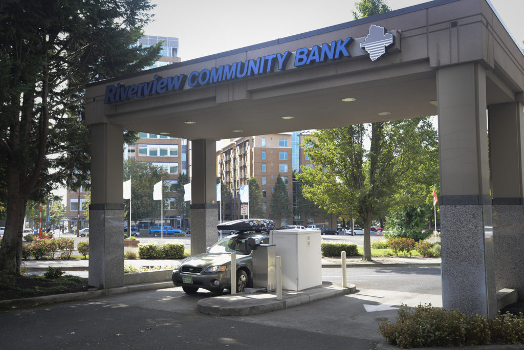 A customer uses the Riverview Community Bank ATM in downtown Vancouver on Thursday.