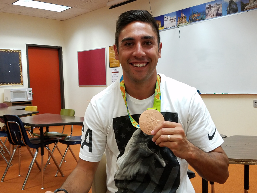 Taylor Sanders, U.S. men's volleyball Olympian shows his bronze medal on Thursday, Sept. 8, 2016, at Prairie High School. He was a guest at the match between Prairie and Skyview.
