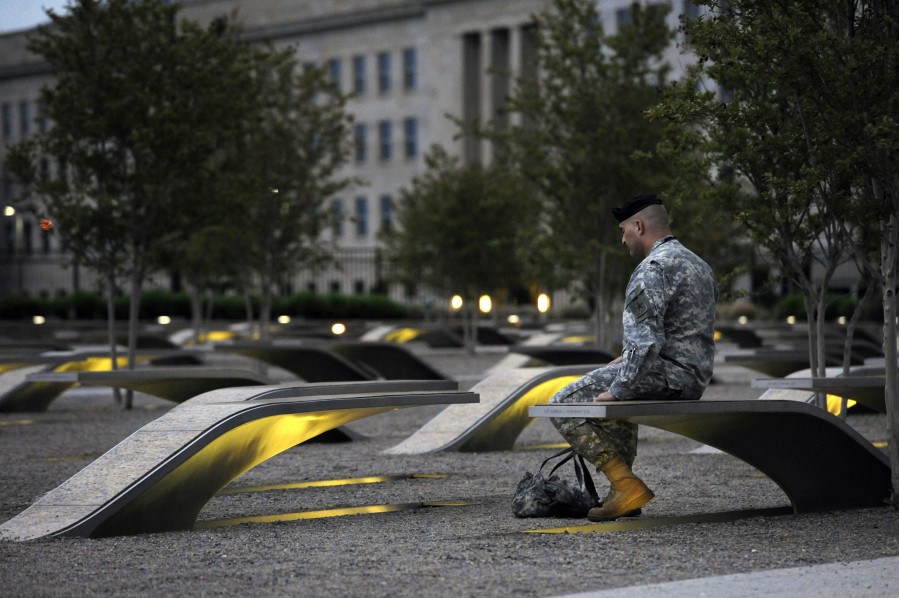 A visitor spends a contemplative moment in 2011 at the Pentagon Memorial, built in honor of those killed there on Sept. 11.