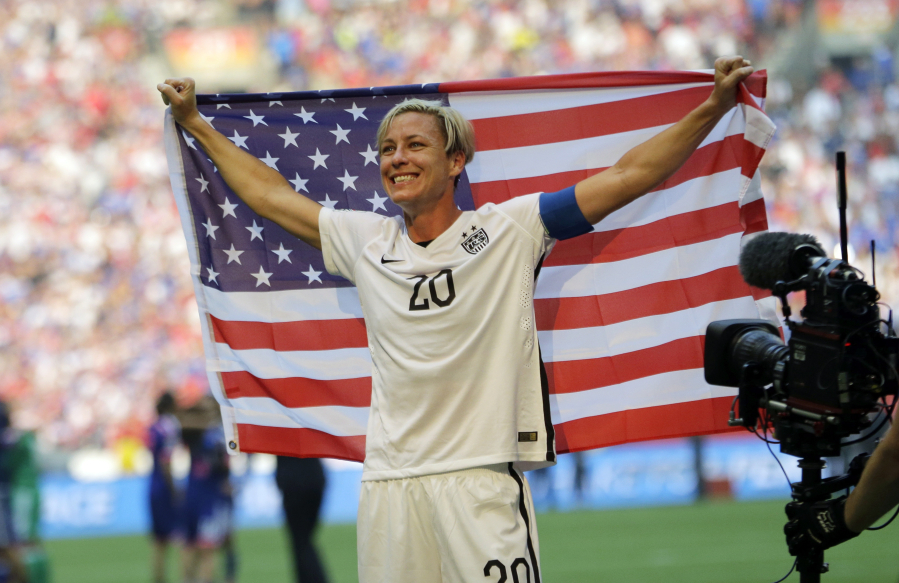 United States&#039; Abby Wambach holds up the U.S. flag as she celebrates after the U.S. beat Japan 5-2 in the FIFA Women&#039;s World Cup soccer championship in Vancouver, British Columbia, Canada, Sunday, July 5, 2015.
