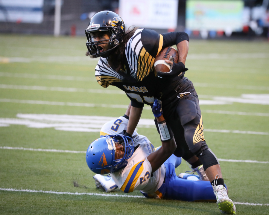 Hudson&#039;s Bay running back Marco Cadiz runs over a would-be tackler during a game against Rochester.