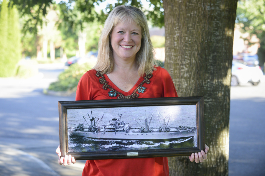 Ellen Townsen holds a photo of the USS Rainier, the ship her father, Arnold Soukup, sailed on during the Korean War. Townsen met some of her dad&#039;s old shipmates when veterans who&#039;d served on the ammunition ship held a reunion last week in Vancouver. At top, Soukup, left, and a shipmate stand next to a sign reminding visitors not to smoke on a Navy ammunition ship.