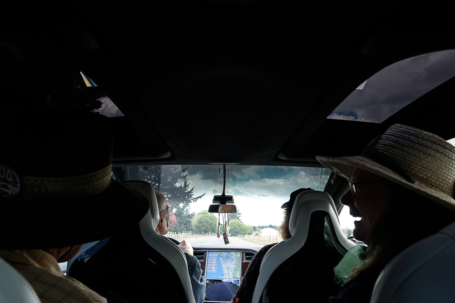 A view from the back seats of a Tesla Model X 90D during a test drive on Sunday in Vancouver. The car belongs to Bill Moore, in the front passenger seat, and his wife, Athena Smith, not pictured, both of Beaverton, Ore. Richard Hovey is behind the wheel; Don and Laura Meyer chat in the second row.