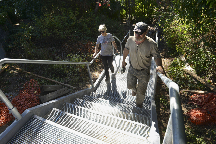Margaret and Art Rojsza of Artus Construction walk up the completed stairs they built at Wintler Park&#039;s east entrance.