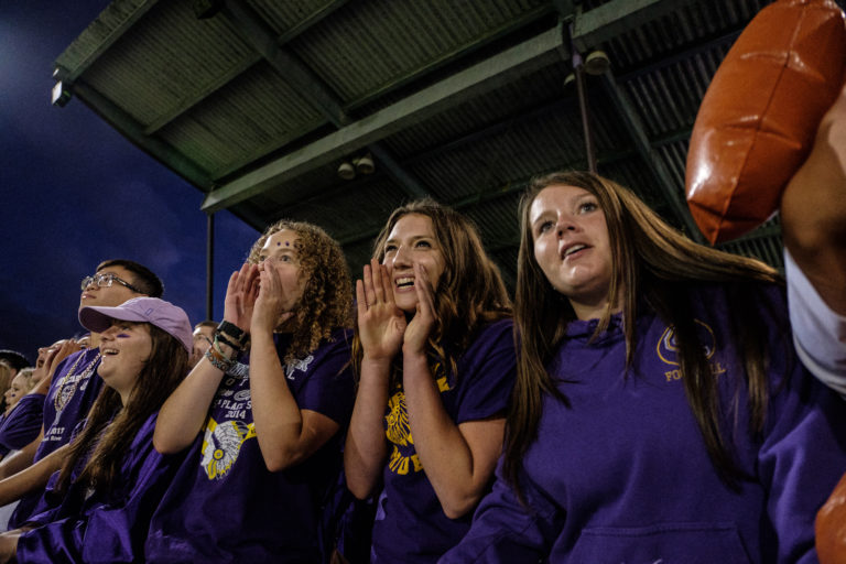Columbia River High School seniors, Lindsay MacNeil, Sara Beeks, and, Kate Kraft, pictured from right, cheer on the CRHS Chieftans during teh Friday night game against the Evergreen Plainsman in Vancouver, September 2, 2016.