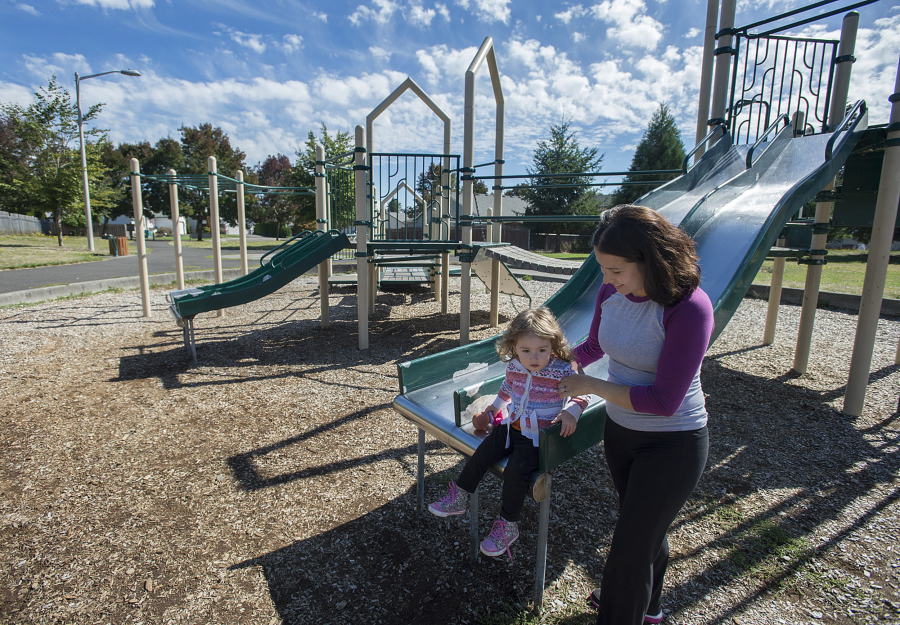 Dallas Cunningham, who will be 2 on Tuesday, explores the playground equipment at Diamond Park in Orchards with her mom, Dae. The two try to walk every day, and the planned improvement of a path through Diamond Park is something they are looking forward to.