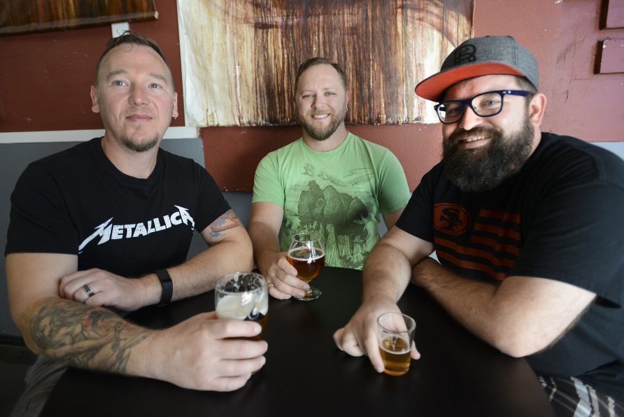 From left, Tom Poffenroth and Devon Bray, co-owners of Loowit Brewing Company, enjoy a beer with Michael Perozzo, founder of ZZoom Media, at Loowit in downtown Vancouver. They&#039;re among the organizers of North Bank Beer Week, which begins Thursday.