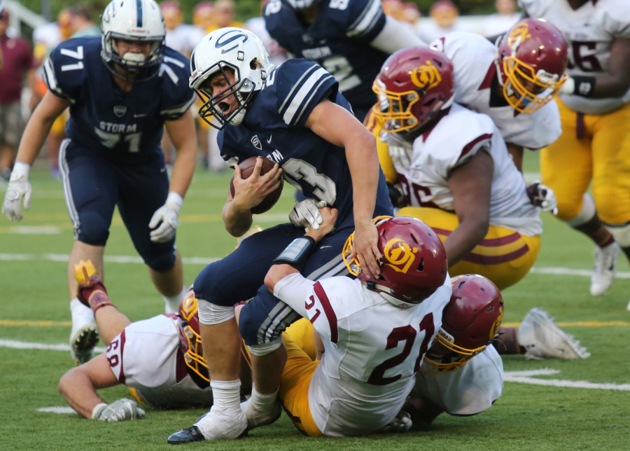 Skyview running back Hayden Froeber is brought down by a trio of O&#039;Dea defenders on Friday at Kiggins Bowl.