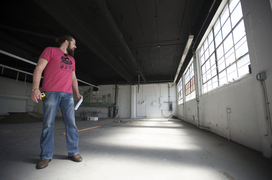 Erick Gill talks about plans for the new barbecue restaurant Thursday afternoon at the former location of Torque Coffee in downtown Vancouver.