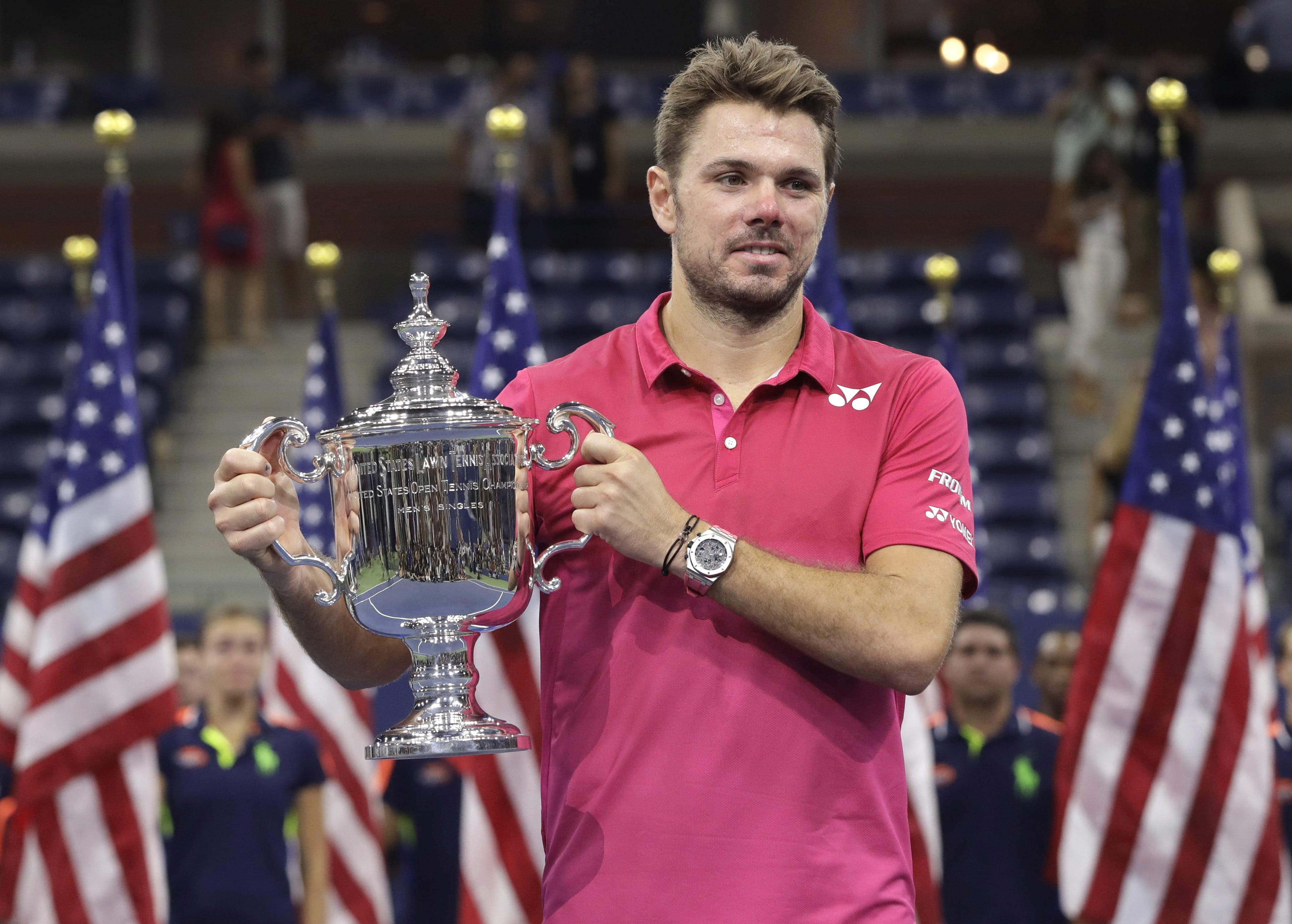 Stan Wawrinka, of Switzerland, holds up the championship trophy after beating Novak Djokovic, of Serbia, to win the men's singles final of the U.S. Open tennis tournament, Sunday, Sept. 11, 2016, in New York.