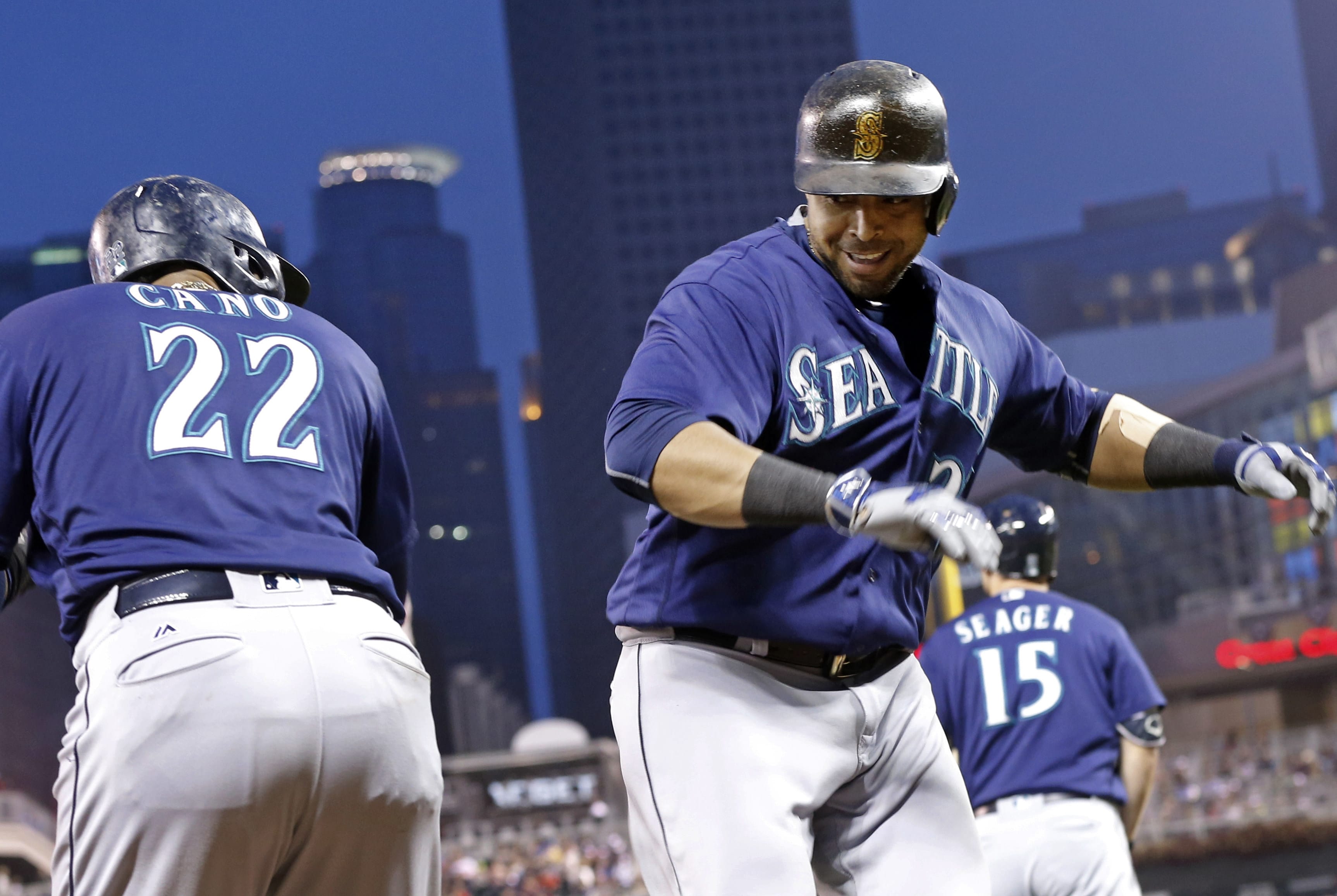 Seattle Mariners' Nelson Cruz, right, and Robinson Cano celebrate Cruz's two-run home run off Minnesota Twins pitcher Tyler Duffey during the fourth inning of a baseball game Saturday, Sept. 24, 2016, in Minneapolis.