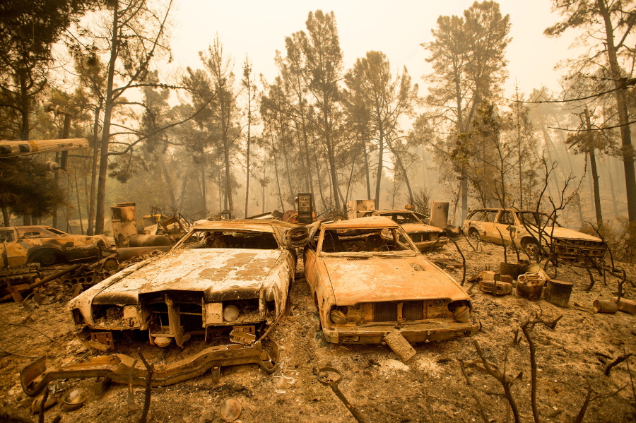 Vintage cars line a property after the Loma fire burned through Loma Chiquita Road near Morgan Hill, Calif. A heat wave stifling drought-stricken California has worsened a wildfire that burned some buildings and forced people from their homes.