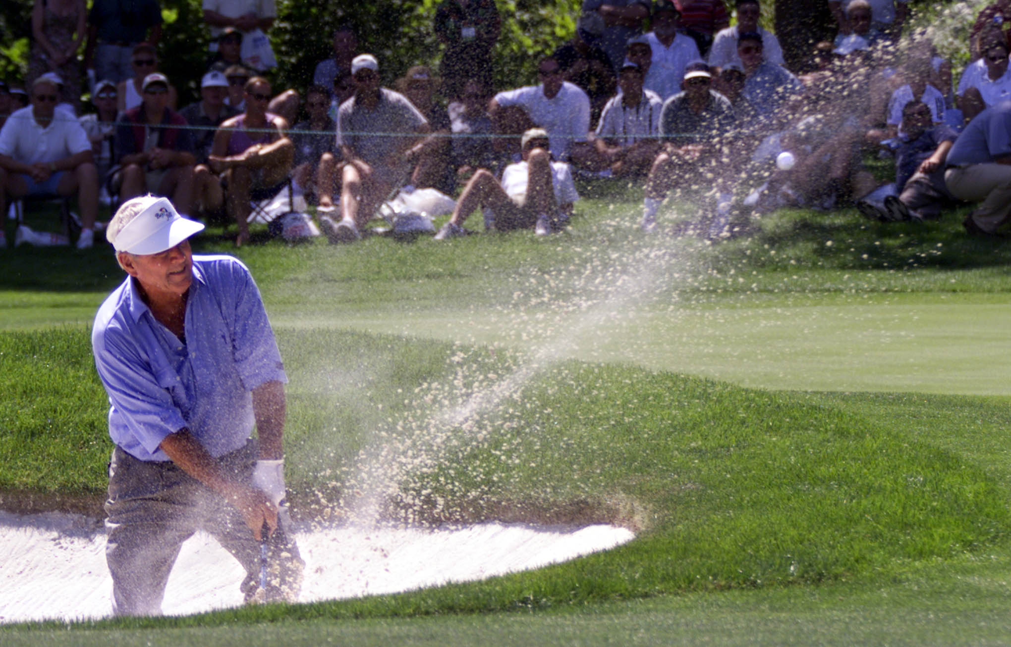 Arnold Palmer chips a shot out of a bunker on the eleventh hole of the Fred Meyer Challenge in Aloha, Ore., on Aug. 23, 1999.