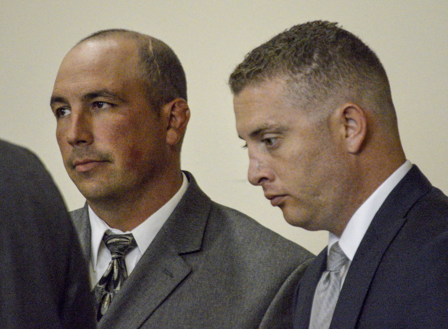 Former Albuquerque Detective Keith Sandy, left, and Officer Dominique Perez speak with attorneys during a 2015 preliminary hearing in Albuquerque, N.M. The case against Perez and Sandy has stirred questions over how police handle conflicts with people in crisis and who have mental illness. Perez???s legal team began laying out its case Wednesday, Sept. 28, 2016, saying he was obligated to shoot to protect the life of a K-9 handler.
