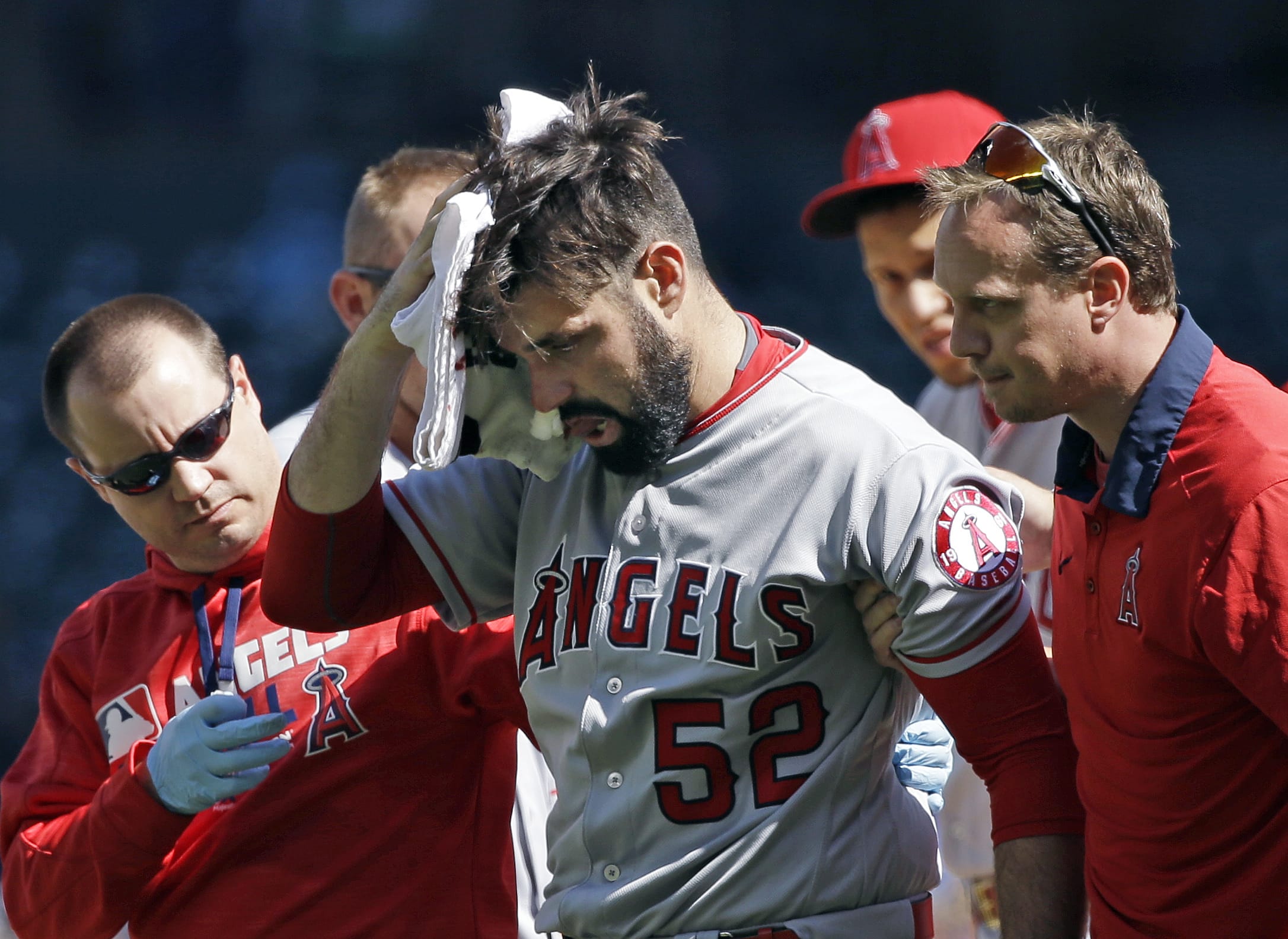 Los Angeles Angels starting pitcher Matt Shoemaker is assisted off the field after being hit by a line drive from Seattle Mariners' Kyle Seager in the second inning of a baseball game, Sunday, Sept. 4, 2016, in Seattle.
