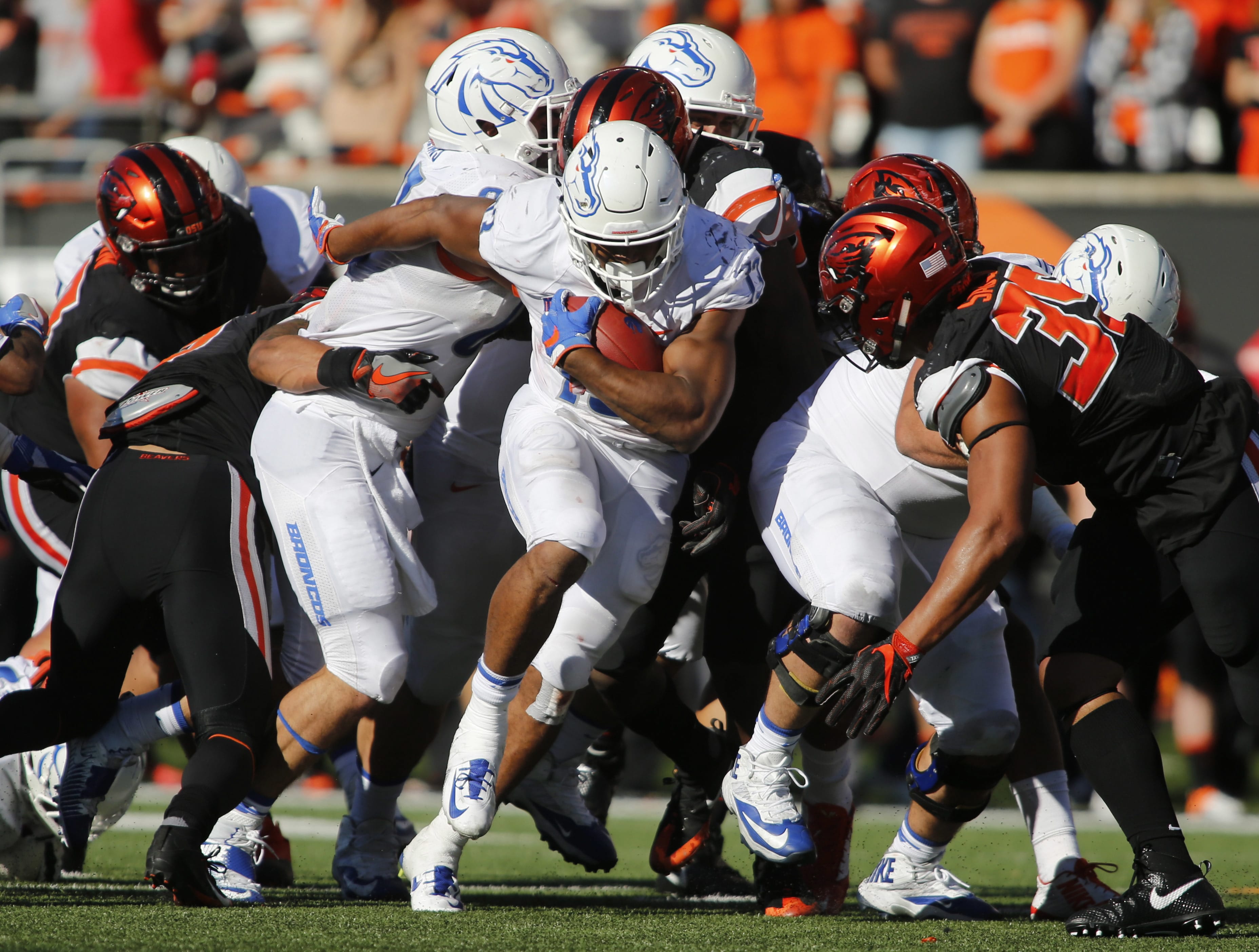 Boise State running back Jeremy McNichols, center, bulls his way through the Oregon State defense in the second half of an NCAA college football game in Corvallis, Ore., on Saturday, Sept. 24, 2016. Boise State won 38-24. (AP Photo/Timothy J.