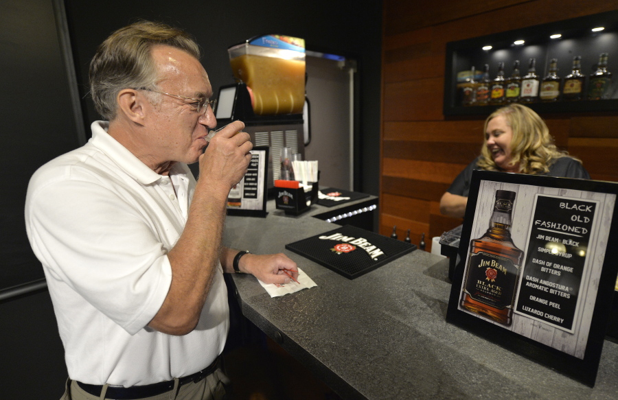 Scott Schwar, left, of Oak Park, Il, orders the first cocktail from Stacy Clark at the new Jim Beam Bourbon Bar located on the grounds of the Jim Beam Distillery, Wednesday, Sep. 14, 2016, in Clermont, Ky. This summer, Kentucky passed legislation allowing distilleries to apply for licences to permit the sale of cocktails by the glass, and Jim Beam was among the first to receive it&#039;s license. (AP Photo/Timothy D. Easley) (Timothy D.